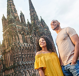 Couple outside cathedral as the sun starts to set